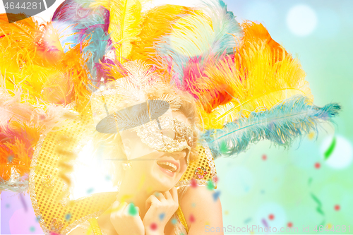 Image of Beautiful young woman in carnival mask