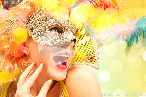 Image of Beautiful young woman in carnival mask