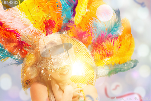 Image of Beautiful young woman in carnival mask