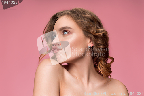 Image of Nice young woman with long wavy silky hair, natural make up looking at camera