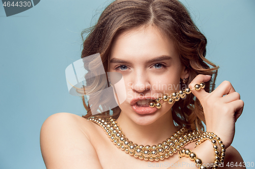 Image of Beautiful young girl in studio with pearl jewelry - earrings, bracelet, necklace.