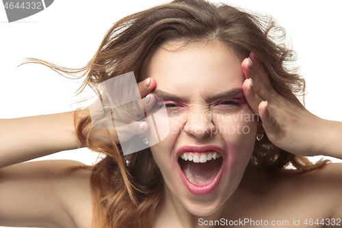 Image of The young emotional angry woman screaming on white studio background
