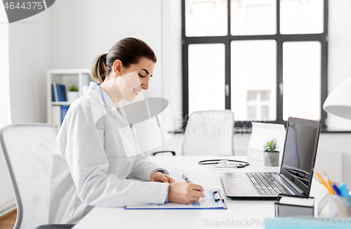 Image of doctor with laptop and medical report at hospital