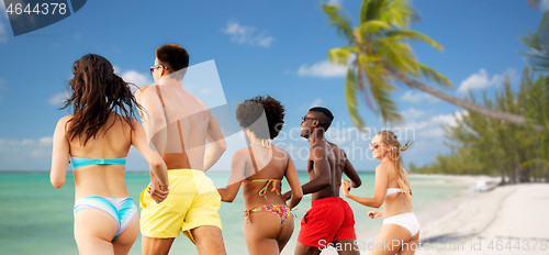 Image of happy friends running on summer beach