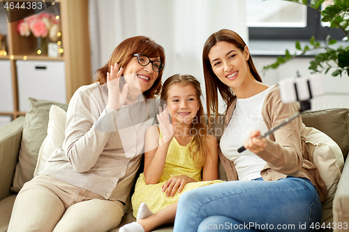 Image of mother, daughter and grandmother taking selfie