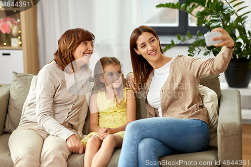 Image of mother, daughter and grandmother taking selfie