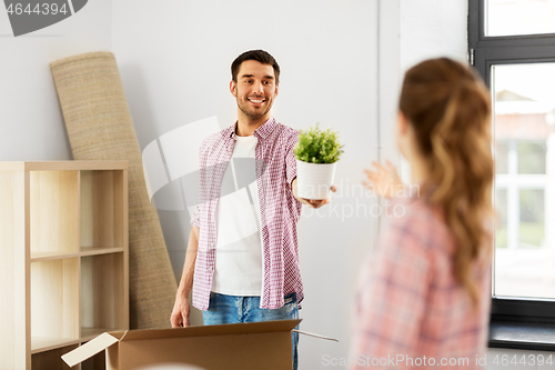 Image of happy couple with stuff moving to new home