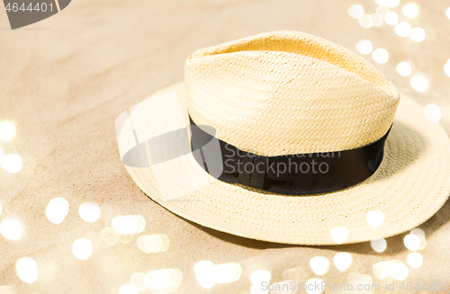 Image of straw hat on beach sand