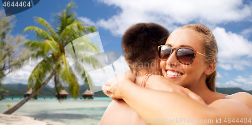 Image of happy couple hugging on summer beach