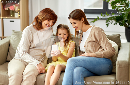 Image of mother, daughter and grandmother with smartphone