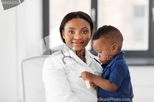 Image of doctor or pediatrician with baby patient at clinic