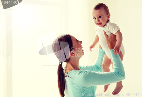 Image of happy young mother with little baby at home