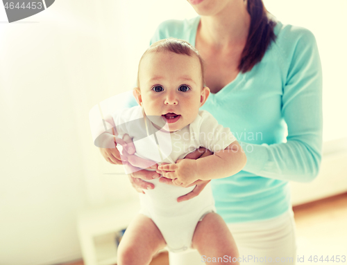 Image of happy young mother with little baby at home