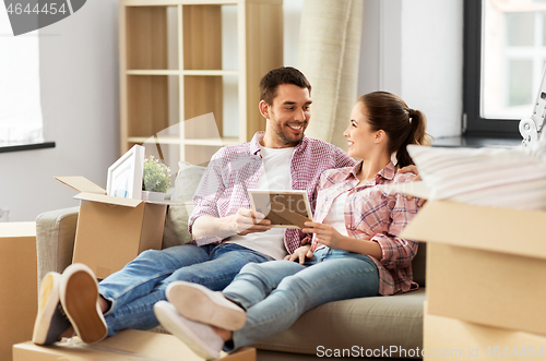 Image of happy couple with boxes moving to new home