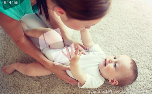 Image of happy mother playing with baby at home