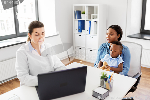 Image of mother with baby and doctor with laptop at clinic