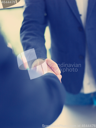 Image of cloasing the deal in modern office interior