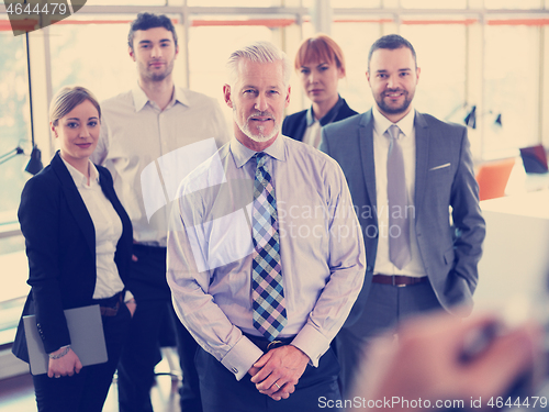 Image of senior business man with his team at office