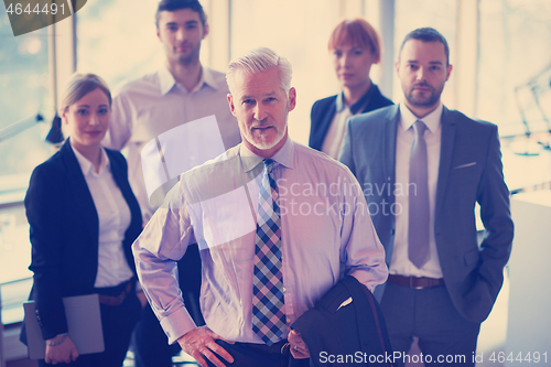 Image of senior business man with his team at office