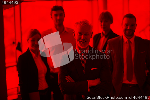 Image of senior business man with his team at office