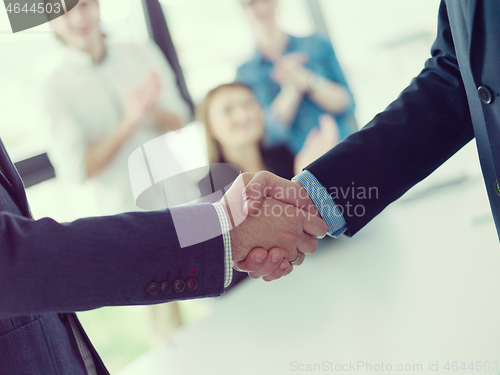 Image of cloasing the deal in modern office interior