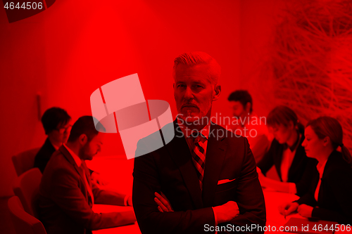 Image of senior business man with his team at office