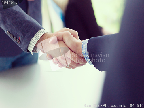 Image of cloasing the deal in modern office interior