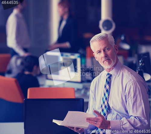 Image of senior business man with his team at office