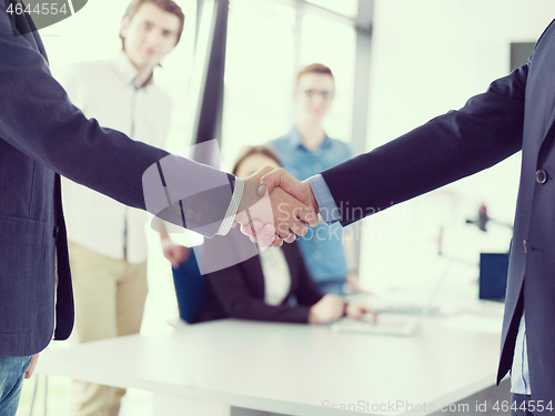 Image of cloasing the deal in modern office interior