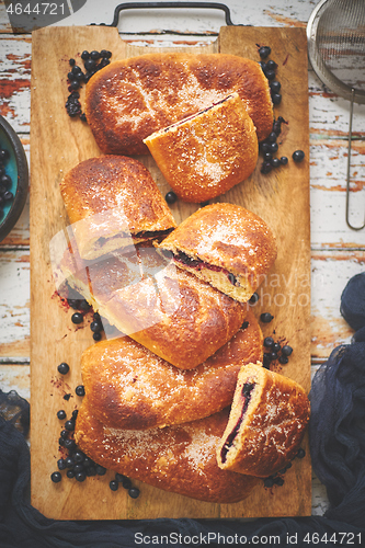 Image of Tasty blueberry bun stuffed with fresh forrest fruits. Traditional polish bun called jagodzianka