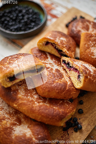 Image of Tasty blueberry bun stuffed with fresh forrest fruits. Traditional polish bun called jagodzianka