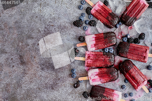 Image of Homemade blackberry and cream ice-creams or popsicles with frozen berries