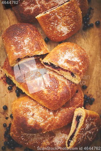 Image of Tasty blueberry bun stuffed with fresh forrest fruits. Traditional polish bun called jagodzianka