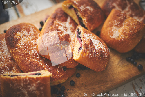 Image of Tasty blueberry bun stuffed with fresh forrest fruits. Traditional polish bun called jagodzianka