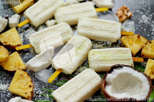 Image of Homemade vegan popsicles made with coconut milk and pineapple. Delicious healthy summer snack