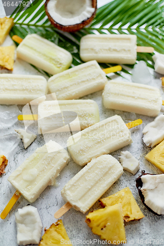 Image of Summer popsicles on stick. Pinacolada flavour. Made with pineapple, cocount milk, rum. Vegan snack