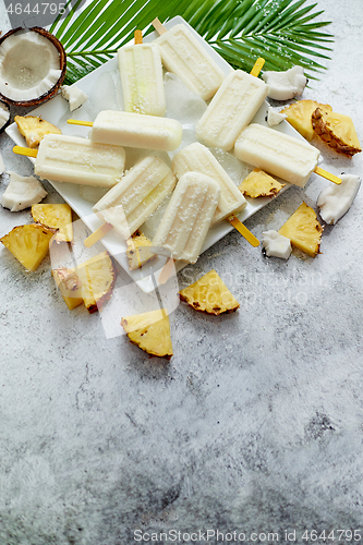 Image of Summer popsicles on stick. Pinacolada flavour. Made with pineapple, cocount milk, rum. Vegan snack