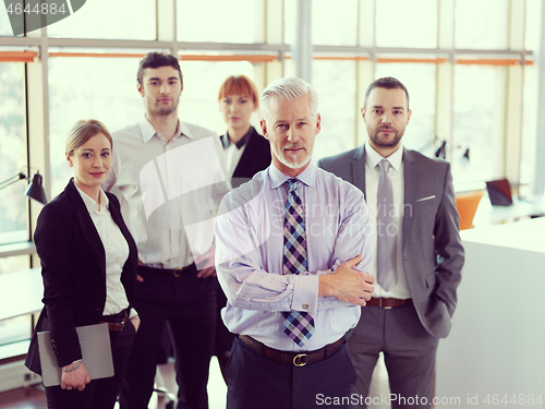 Image of senior business man with his team at office