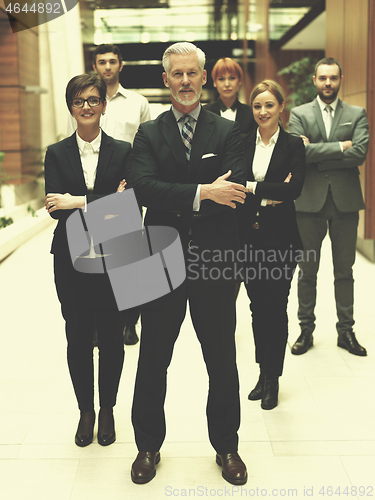 Image of senior business man with his team at office