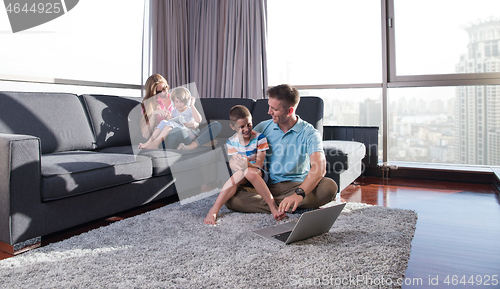 Image of Happy family playing a video game