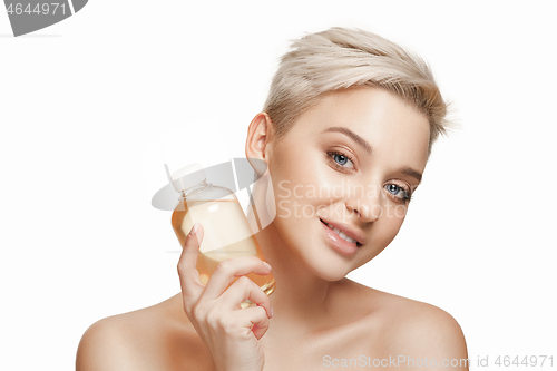 Image of Beauty concept. The pretty woman with perfect skin holding oil bottle