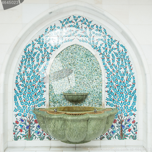 Image of Tiled ornament drinking water fountains on forecourt of islamic mosque