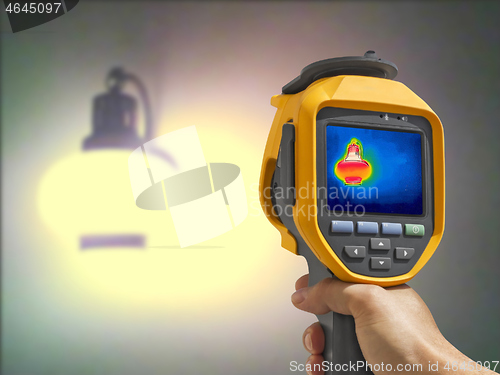Image of Recording whit Thermal camera, Lighted classic lamp on the wall