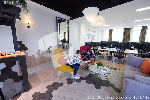 Image of Business people Working In Relaxation Area Of Modern Office