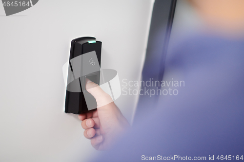 Image of man pressing fingerprint scanner