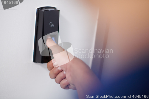 Image of man pressing fingerprint scanner