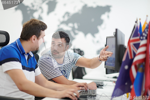 Image of two male software developers working on computer