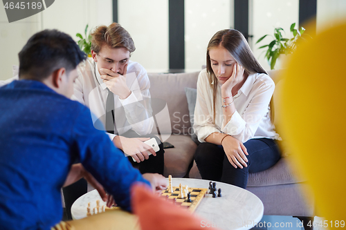 Image of multiethnic group of business people playing chess