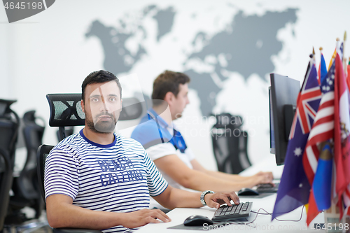 Image of two male software developers working on computer