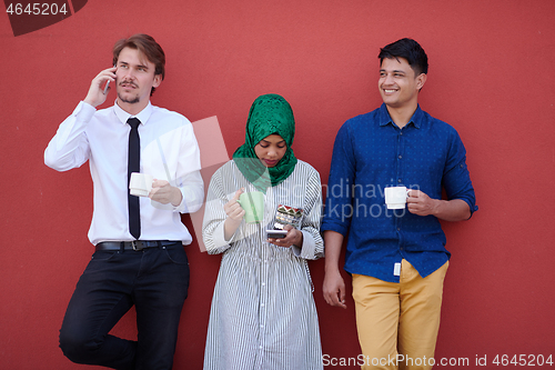 Image of multiethnic group of casual business people during coffee break